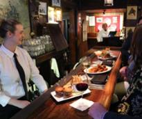woman and diners at a restaurant bar