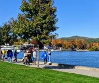 people by boardwalk in lake george in fall