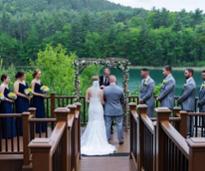 wedding ceremony with lake and mountains in background