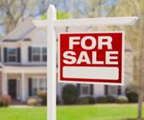 for sale sign in front of house