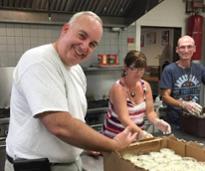 people in a kitchen volunteering