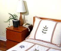 a bedroom with a nightstand and plant