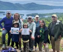 group of people on a hike by a lake