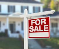 for sale sign in front of house