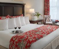 two glasses of wine on bed