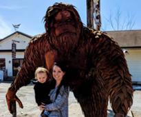 mom and kid with sasquatch statue