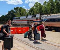 people waiting by a train