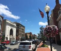 a sidewalk view of downtown glens falls ny