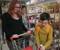 woman and two kids in a food pantry