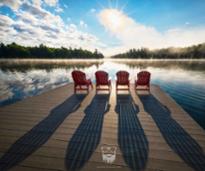 sun shining over a lake dock