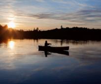 a fisherman on a pond