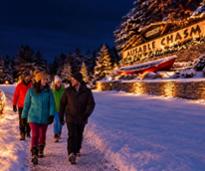 people walking by Ausable Chasm sign in winter