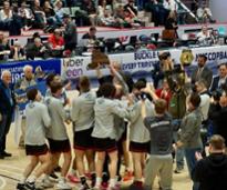boy's high school basketball team celebrating on the court