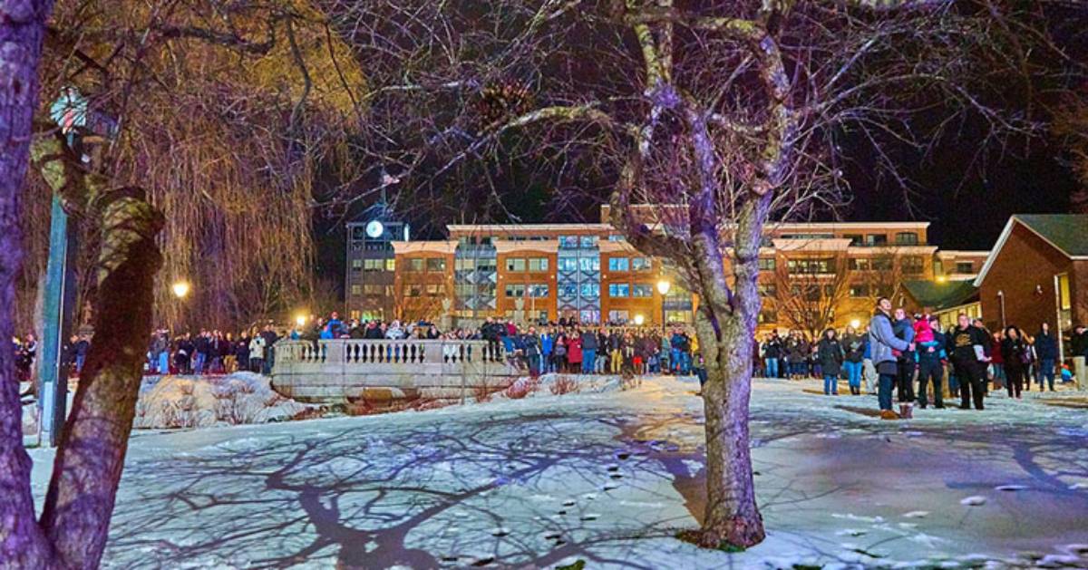 people at an outdoor winter event near a building and park