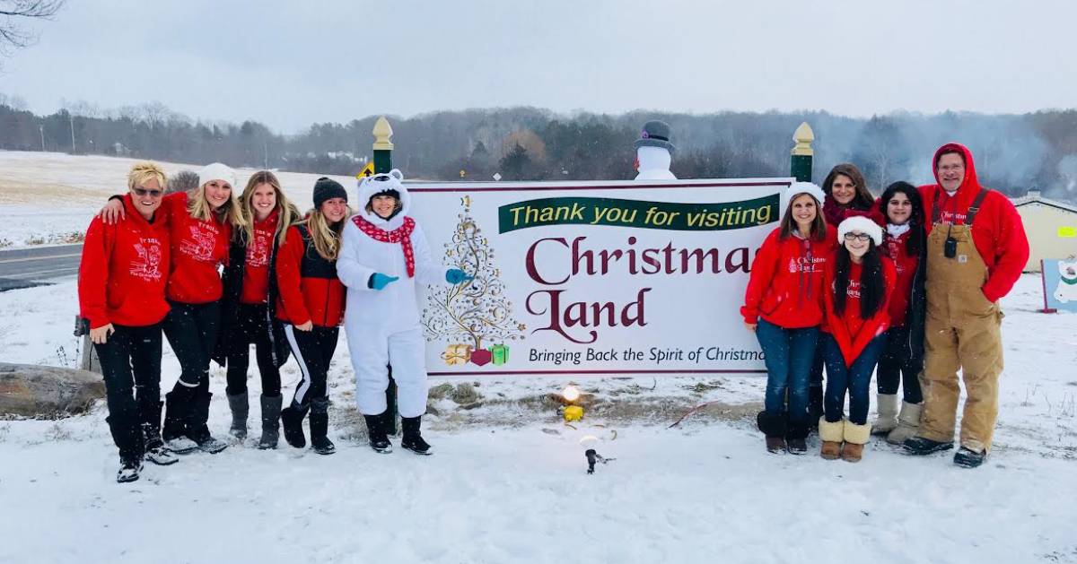 Christmas Land sign and people standing outdoors nearby