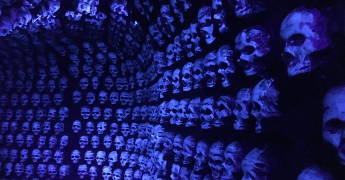 Spooky room of skulls lit up in purple