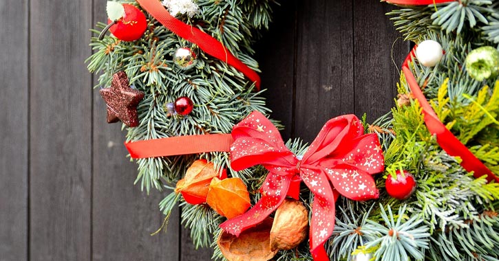 wreath with holiday decorations on it