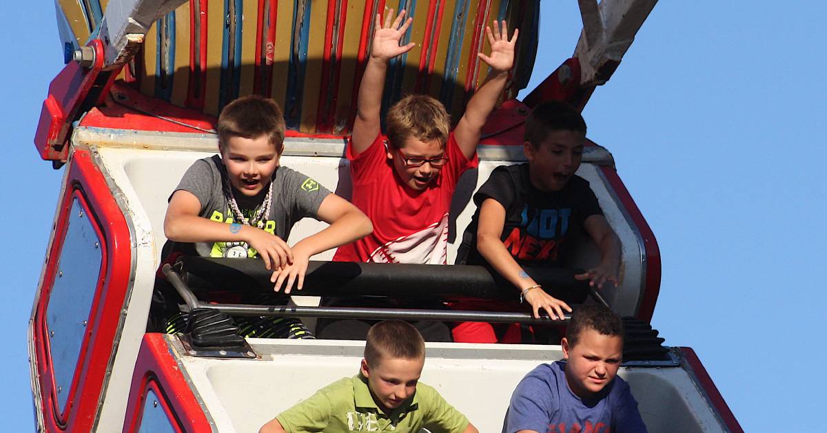 kids on a swing ride at the fair