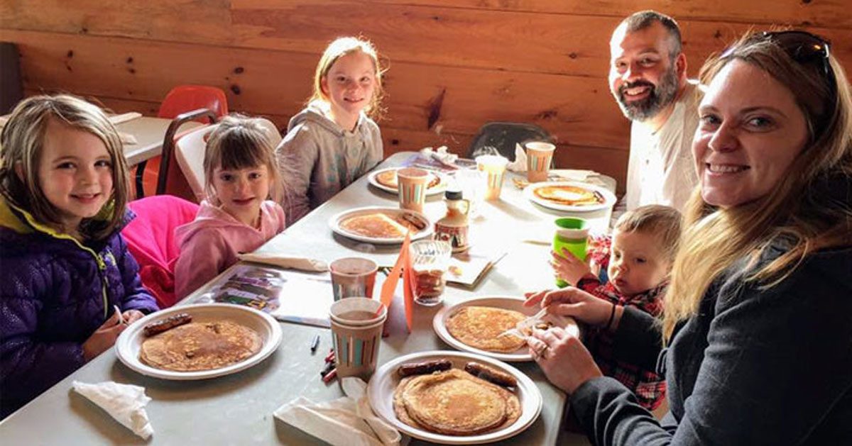 family enjoying pancake breakfast