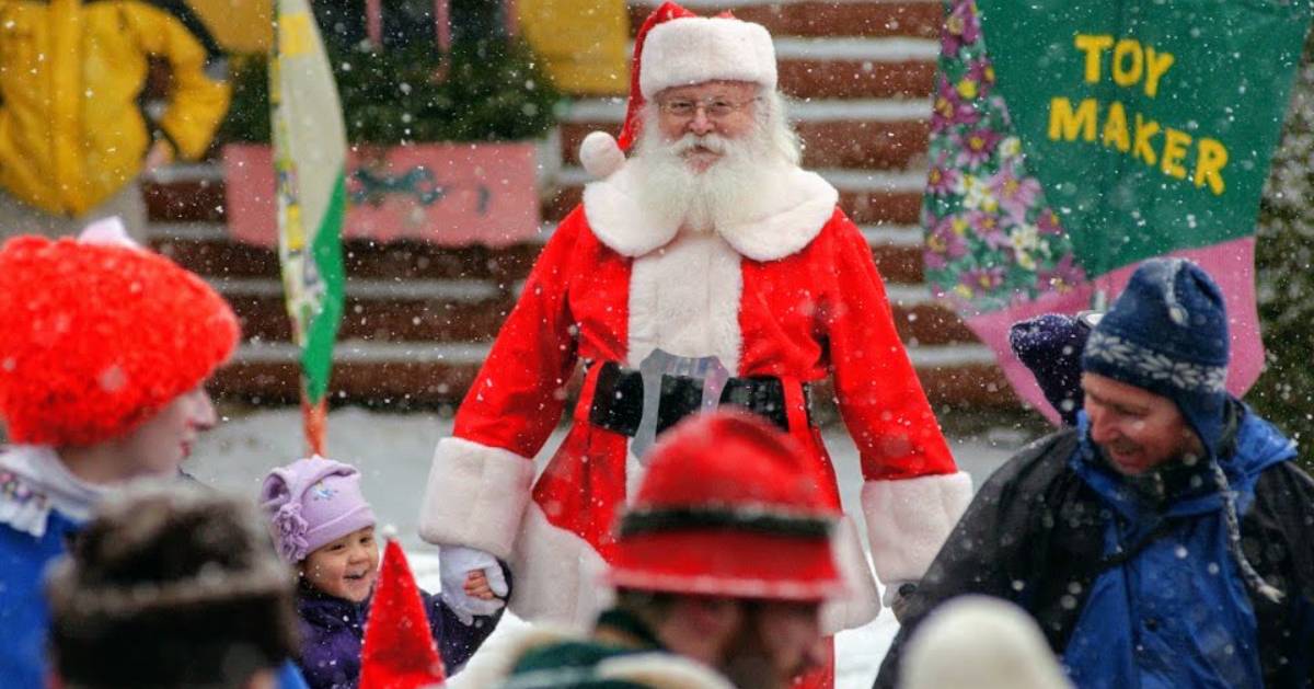Santa walking with crowd in snow