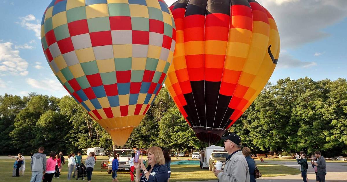 three hot air balloons, two with goofy faces