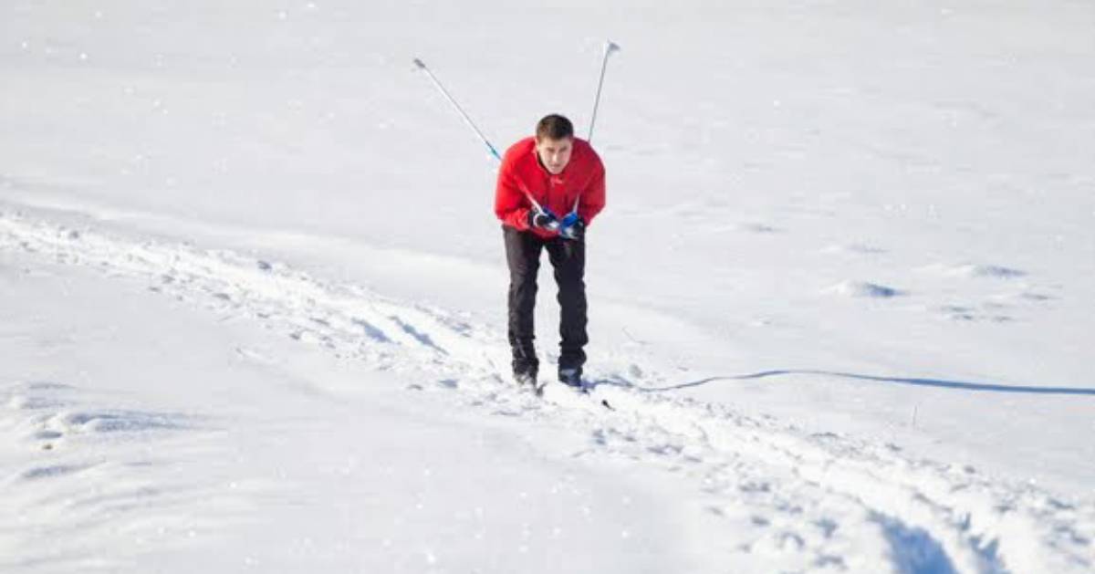 guy in red shirt cross-country skiing