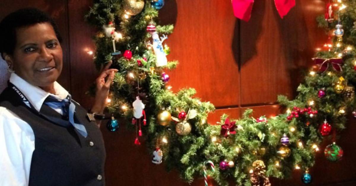 woman by a holiday wreath on a train