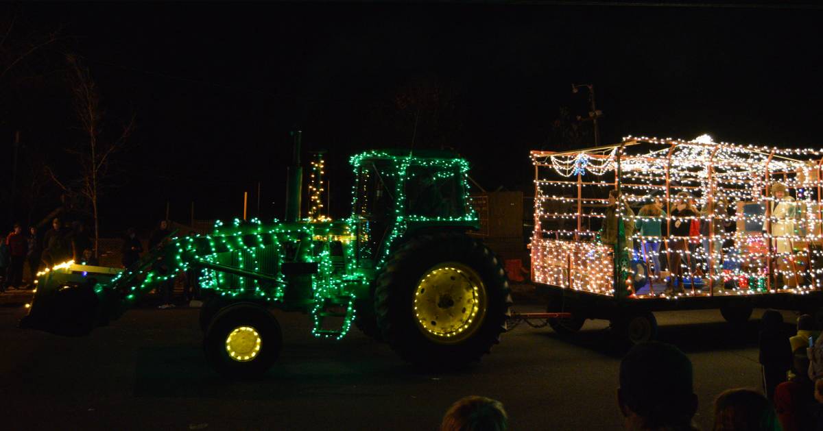 green lighted tractor pulled wagon in holiday parade