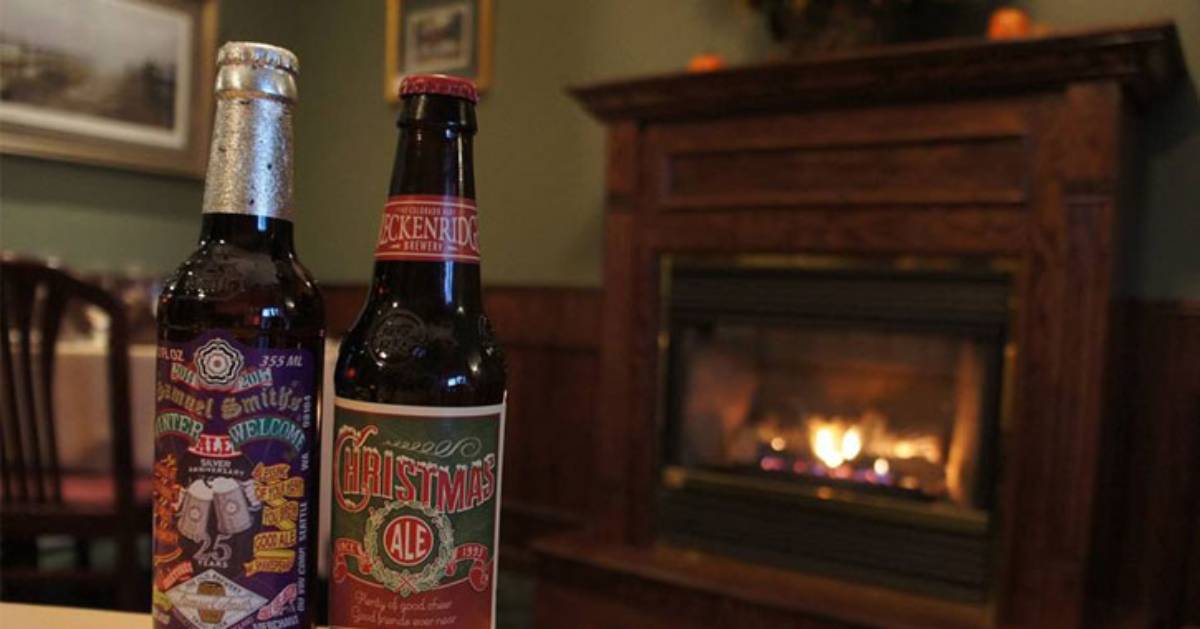 two beer bottles by a fireplace