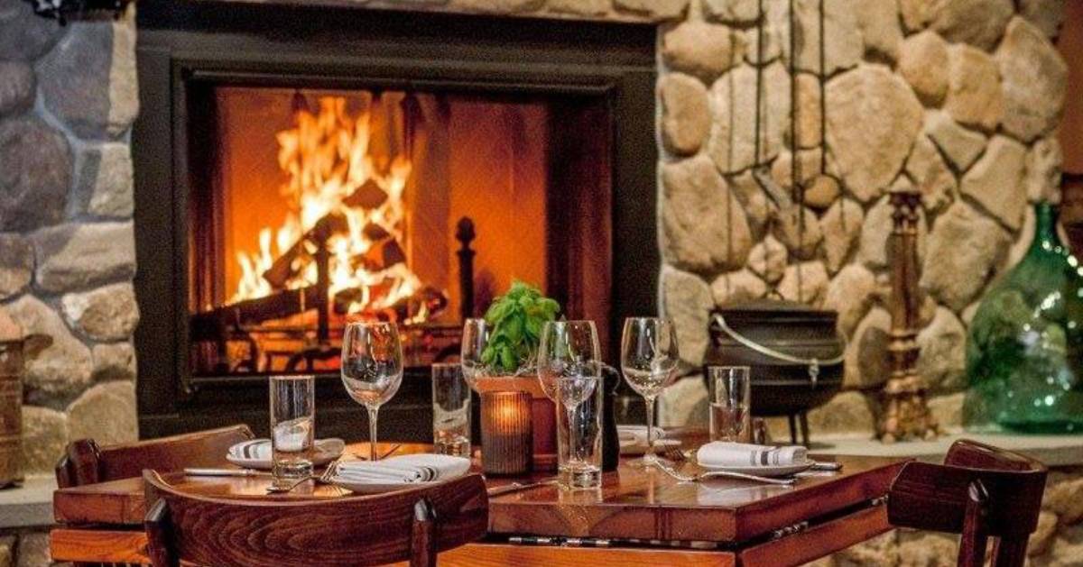 table with drink glasses near a fireplace