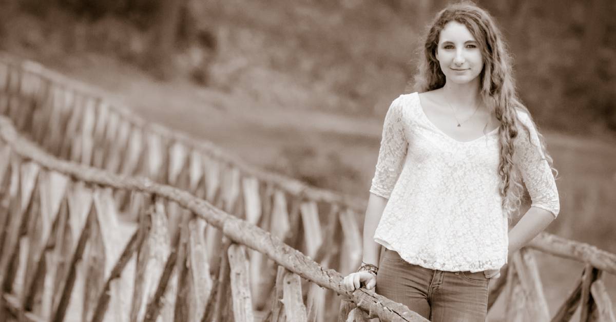 portrait of a girl standing on a bridge