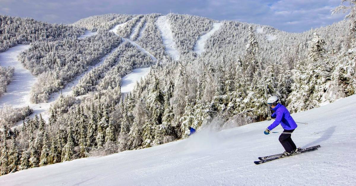 person downhill skiing wearing blue