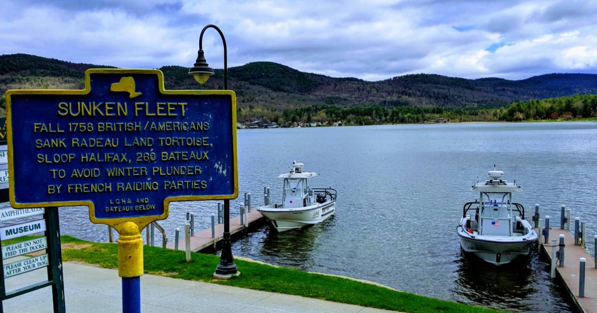 Sunken Fleet historical sign near boats in the water