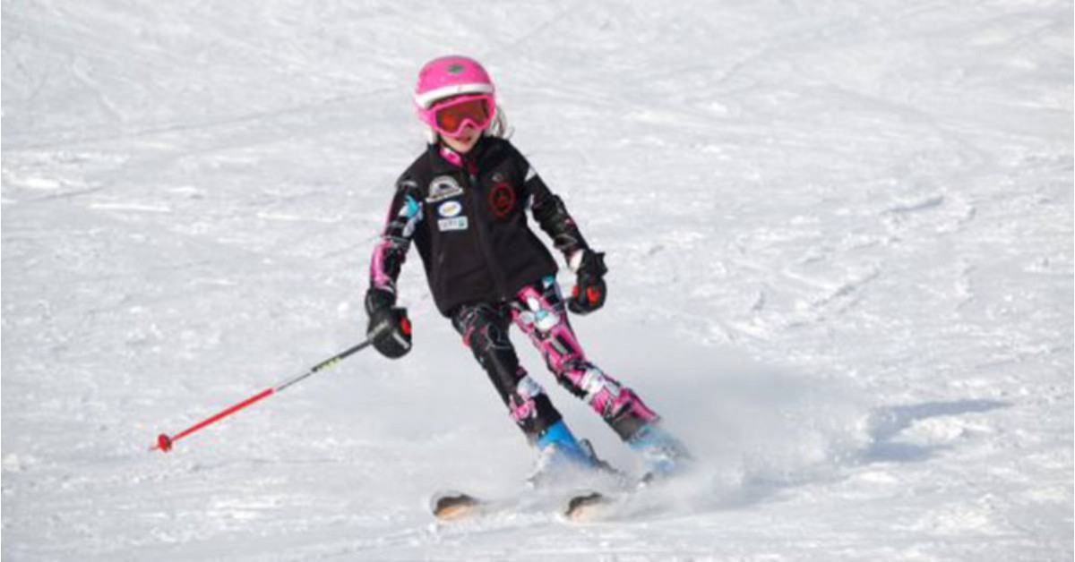 a young girl downhill skiing