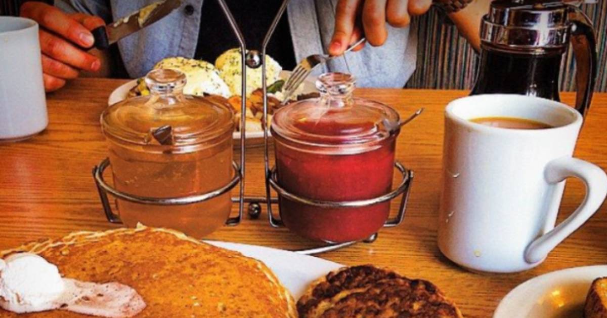 person eating breakfast food at a table