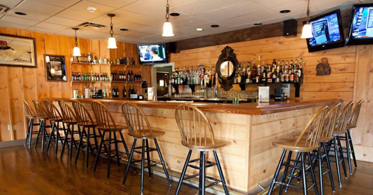 wooden bar with chairs along one side