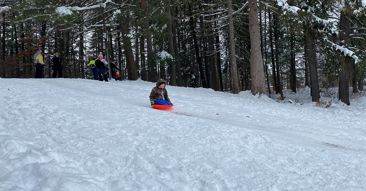 people sledding at crandall park