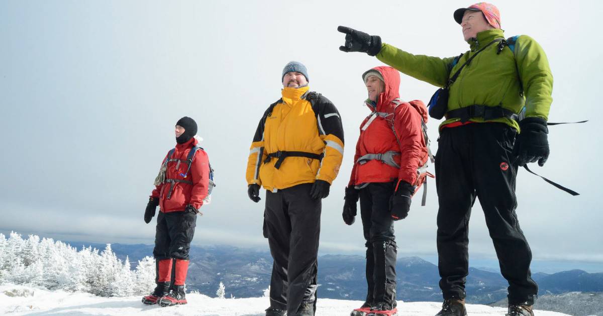 four winter hikers on mountain