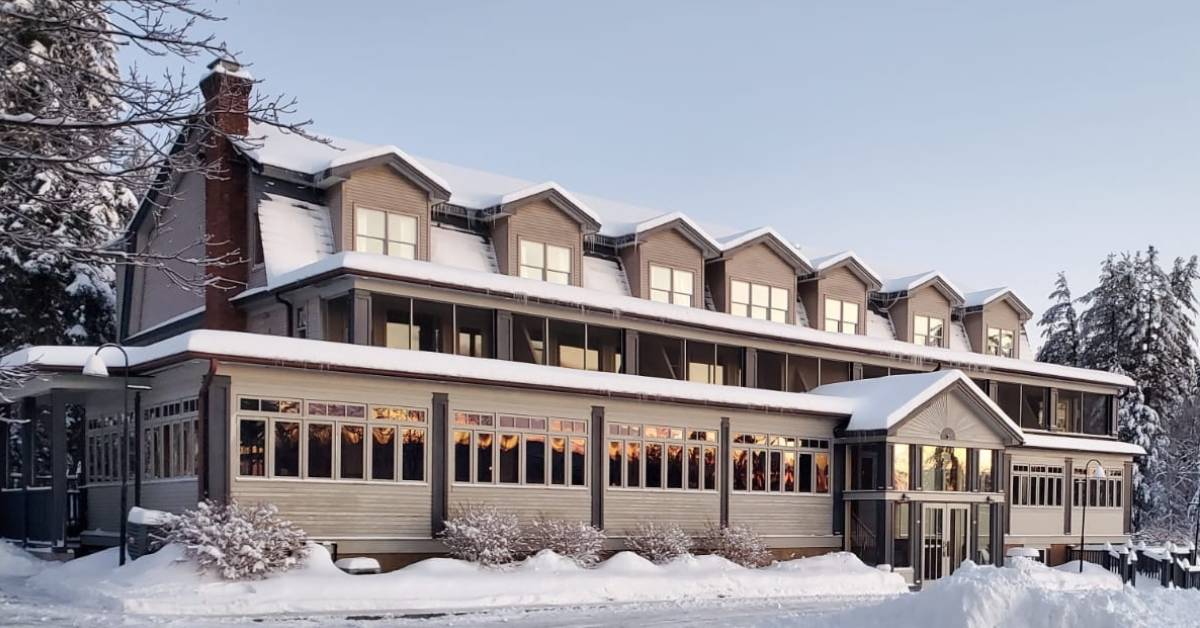 a hotel with snow on the ground outside it