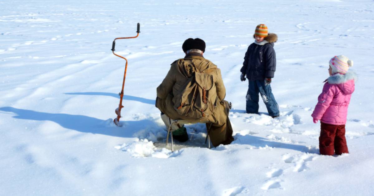 man with kids ice fishing