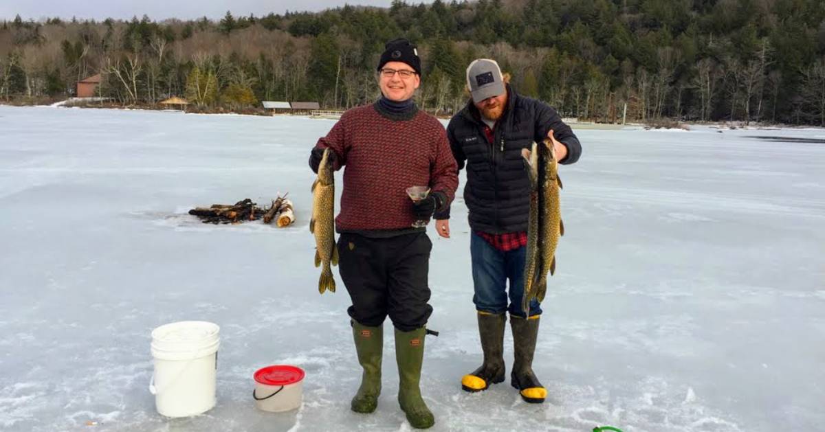 two guys with fish they caught ice fishing