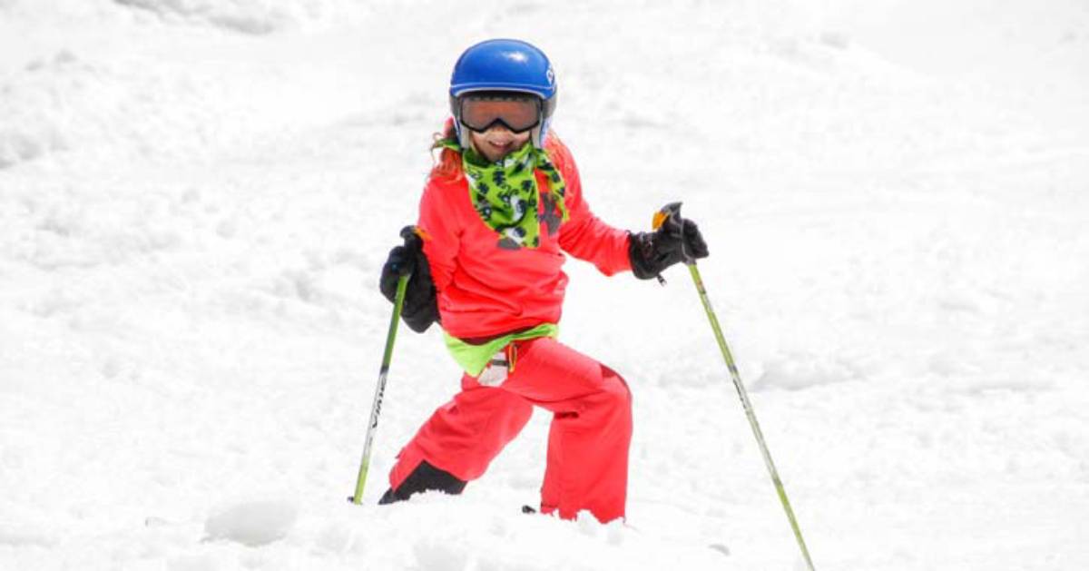 a girl skiing in snow