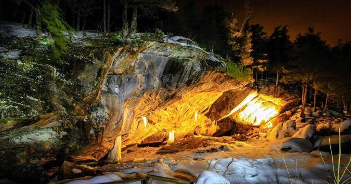 a large cave entrance with yellow lights