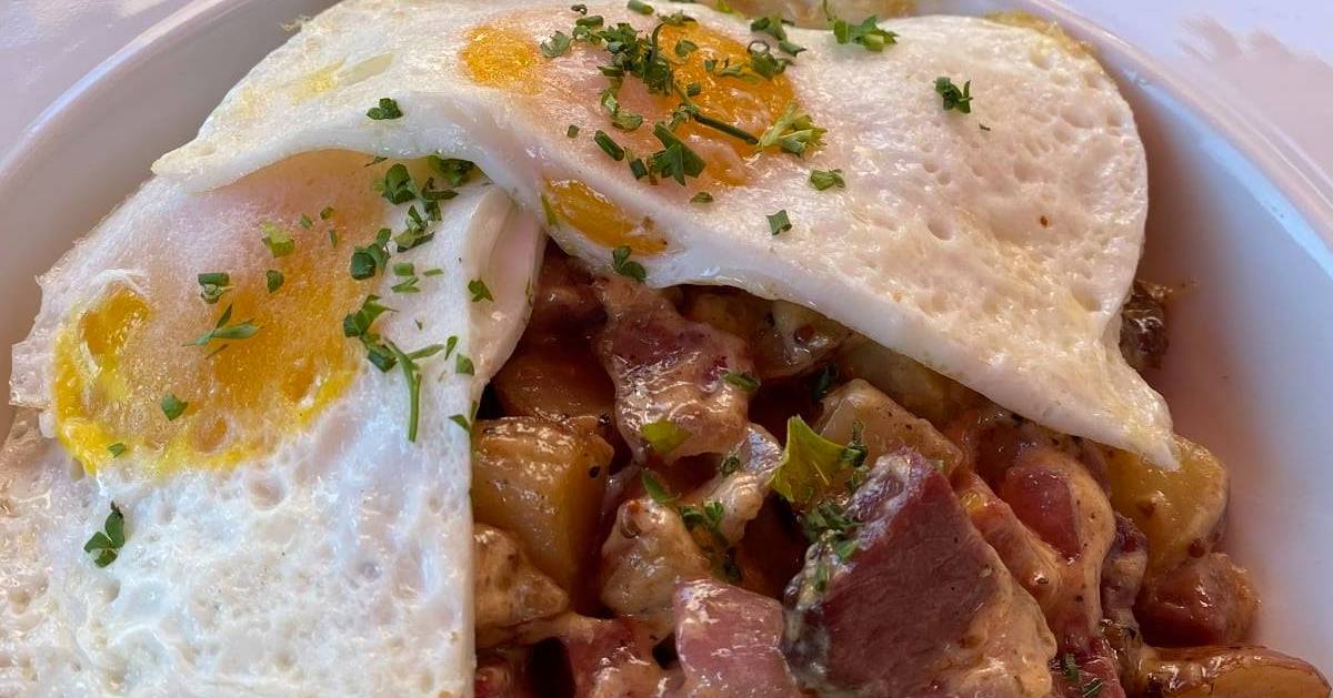 breakfast plate with fried eggs and home fries