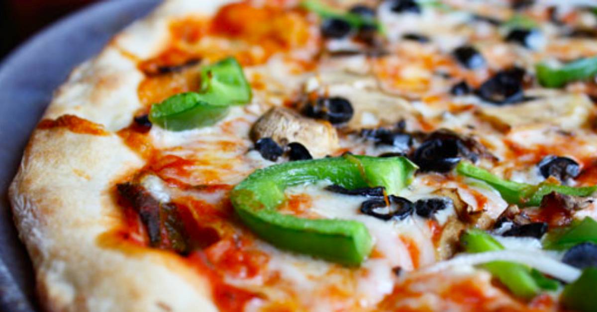 pizza with green pepper, olives, and mushrooms