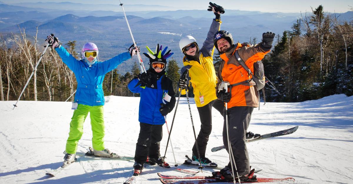 two kids, a woman, and a man in ski gear on mountain