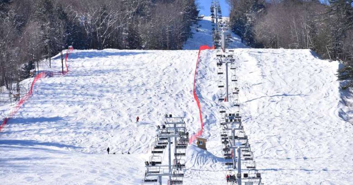 a chair lift and snowy hill at a ski resort