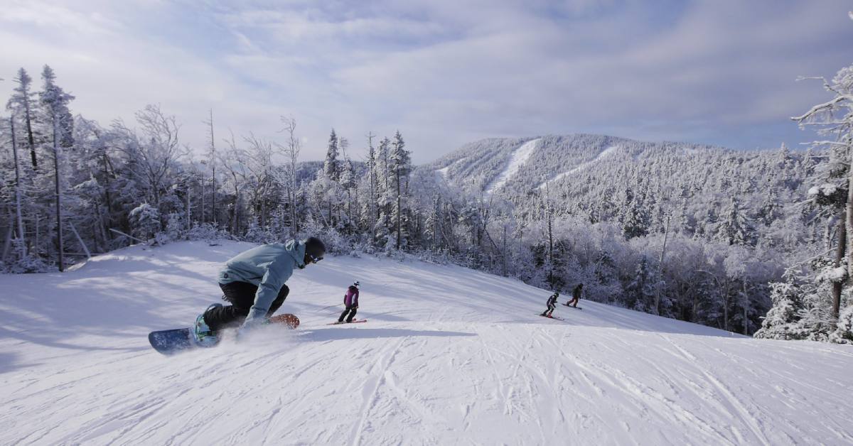 snowboarders and skiers on a trail at gore mountain