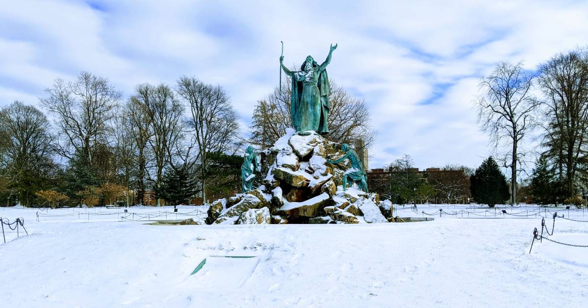 green statue monument in a snowy public park