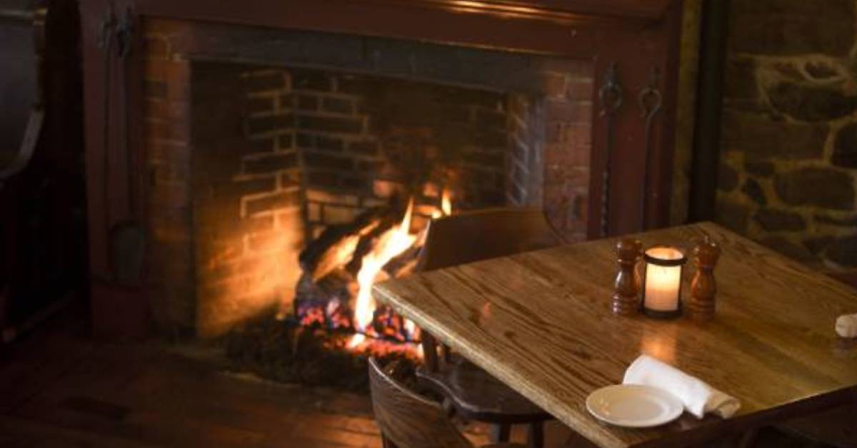 a wooden table near a fireplace